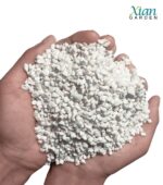 Lightweight white volcanic perlite granules mixed with dark potting soil.